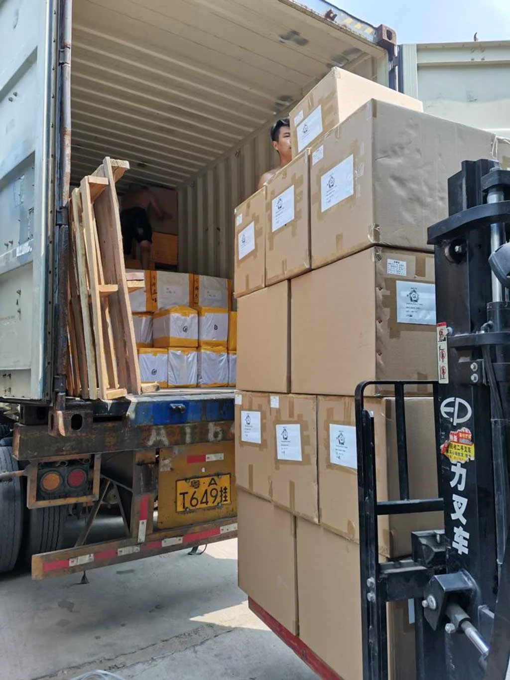Loading boxed goods into a shipping container