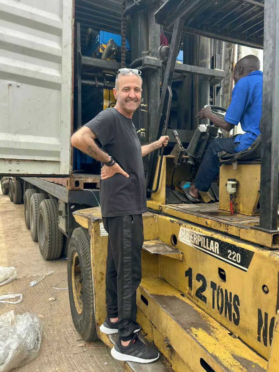 Forklift unloading machinery at a container