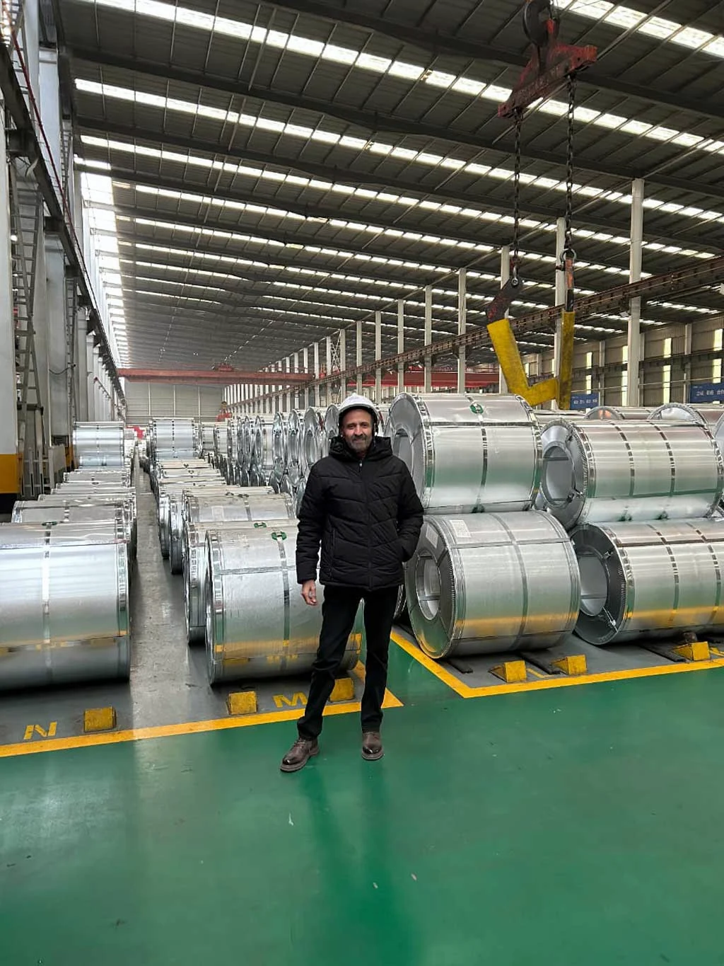 Factory visit beside steel coils