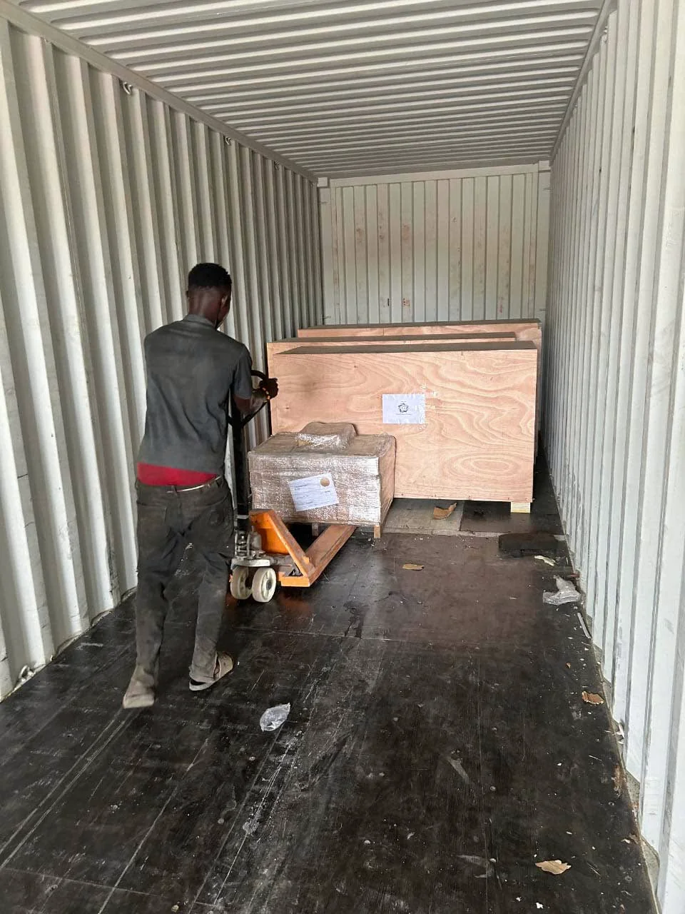 Loading packaged equipment into a shipping container